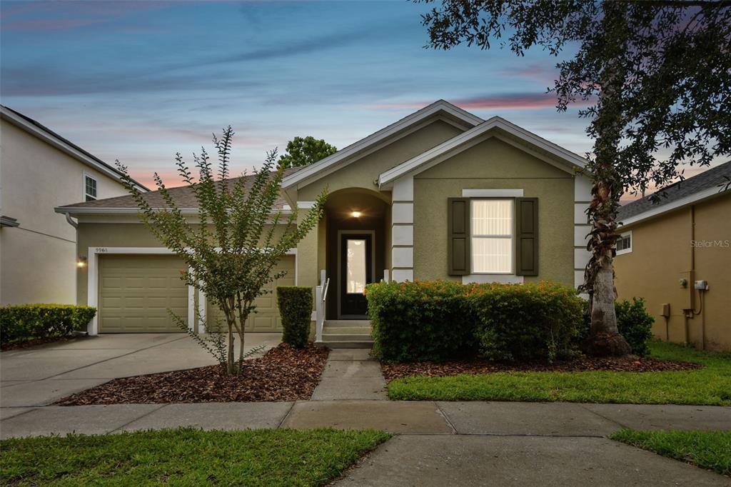 9968 Hartford Maroon Road Orlando, FL 32827 - Photo 1 of 1 a front view of house with yard and green space