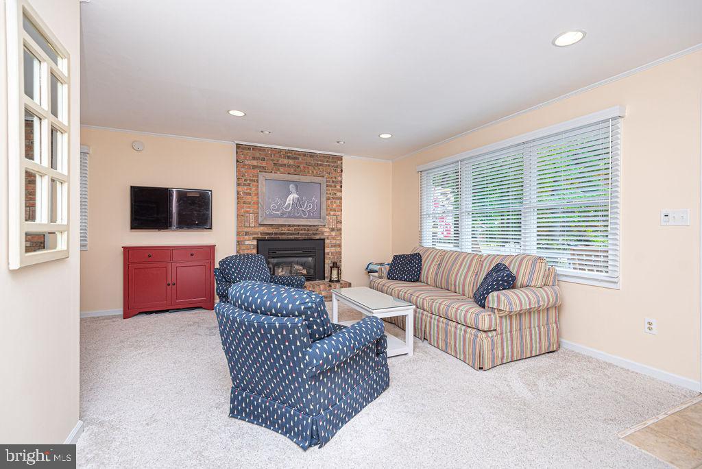 33 Falcon Bridge Road Ocean Pines, MD 21811 - Photo 12 of 71 a living room with furniture a fireplace and a flat screen tv