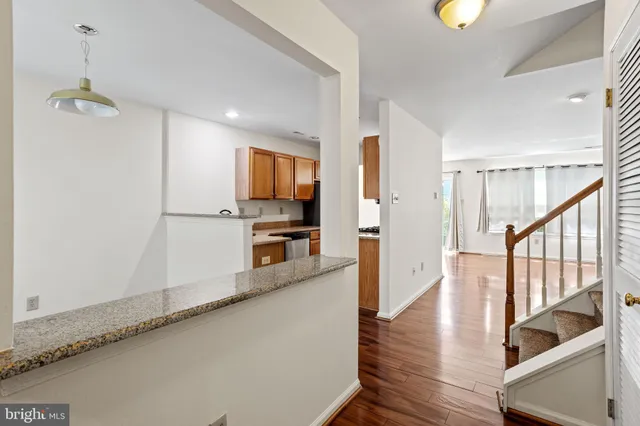 a view of a kitchen with wooden floor and a window