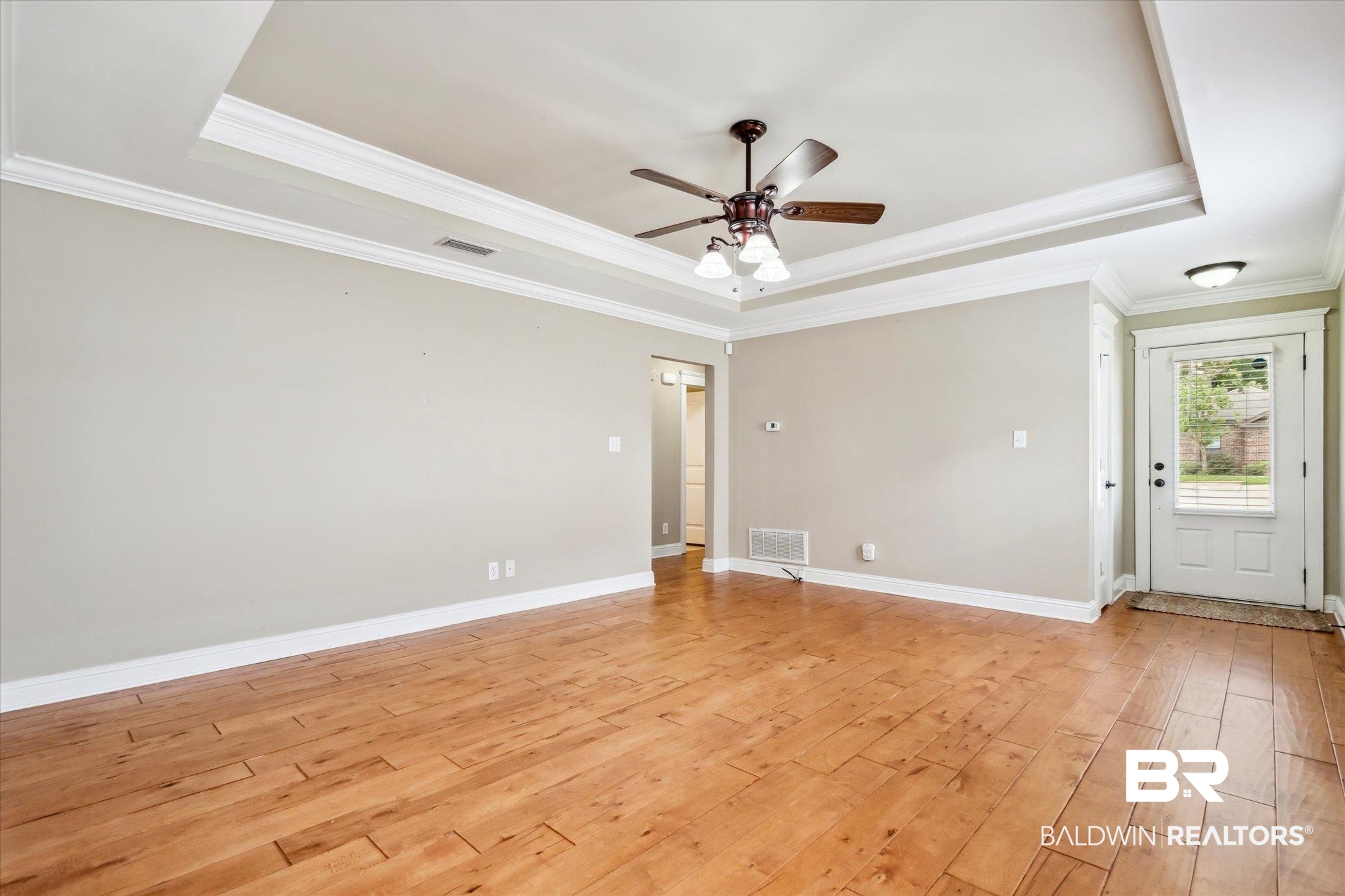 9 Breydon Court Mobile, AL 36608 - Photo 2 of 20 Spare room with light hardwood / wood-style floors, ceiling fan, crown molding, and a tray ceiling