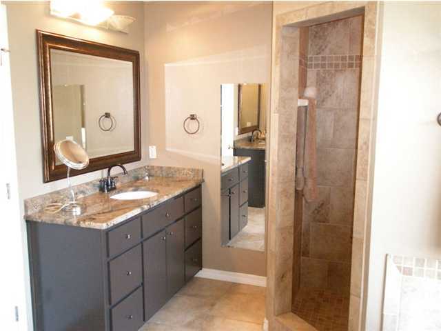2445 Crescent Road Navarre, FL 32566 - Photo 15 of 25 a bathroom with a granite countertop sink a mirror and a shower