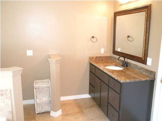 2445 Crescent Road Navarre, FL 32566 - Photo 17 of 25 a bathroom with a granite countertop sink and a mirror