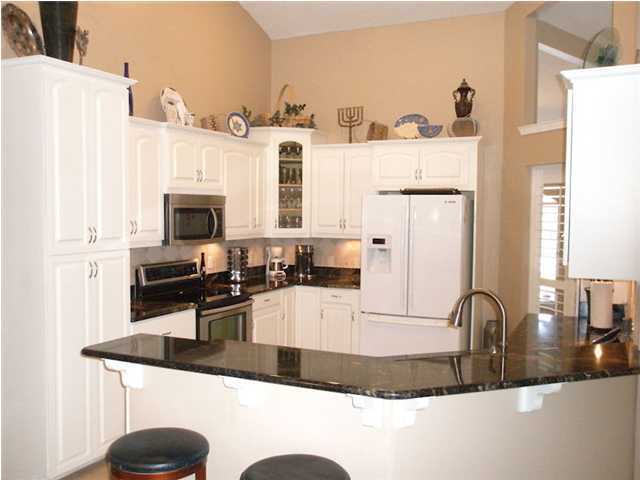 2445 Crescent Road Navarre, FL 32566 - Photo 3 of 25 a kitchen with stainless steel appliances granite countertop a sink a stove and a refrigerator