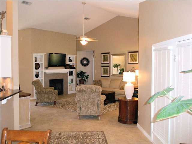 2445 Crescent Road Navarre, FL 32566 - Photo 8 of 25 a living room with furniture a fireplace and a flat screen tv