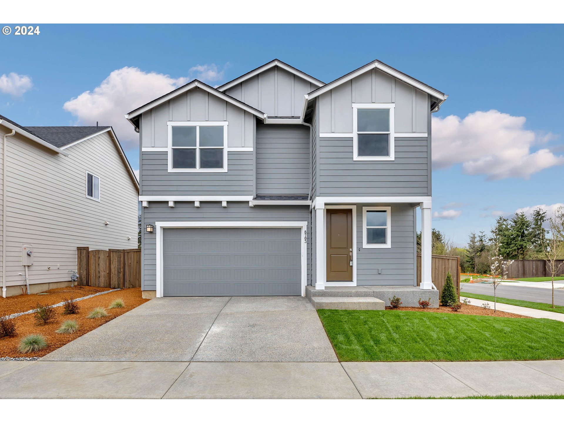 208 South 87th Avenue, Unit 60 Ridgefield, WA 98642 - Photo 1 of 32 a front view of a house with a yard and garage