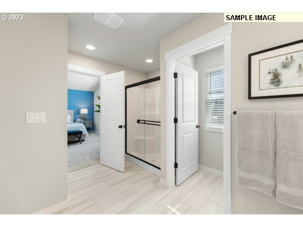 208 South 87th Avenue, Unit 60 Ridgefield, WA 98642 - Photo 13 of 32 a open hall with wooden floor and a bathroom