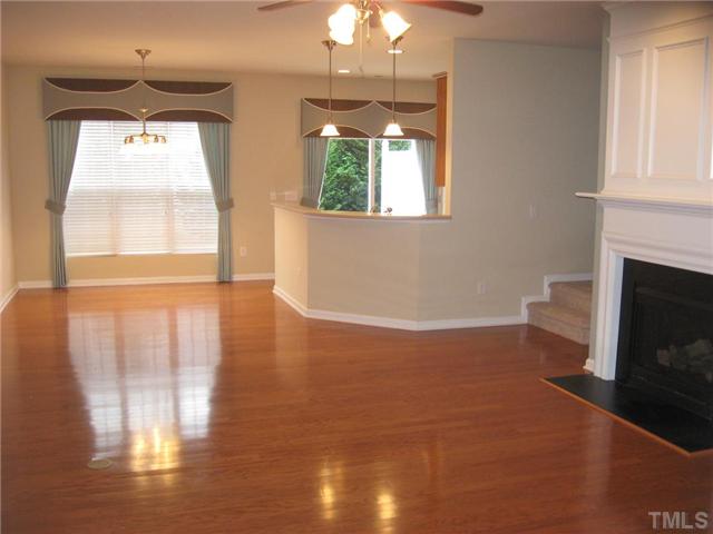 7025 Racine Way Raleigh, NC 27615 - Photo 2 of 7 View of the living room area from the entrance area, The bright and spacious living area is complemented by the stylish window treatments and neutral tones of the walls and floors.