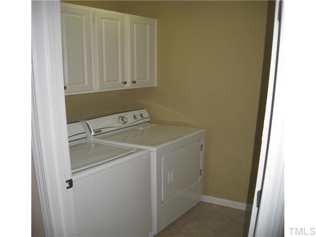 7025 Racine Way Raleigh, NC 27615 - Photo 7 of 7 The laudry room, located upstairs, is finished with tile flooring and plenty of cabinet space. (The washer and dryer do not convey)