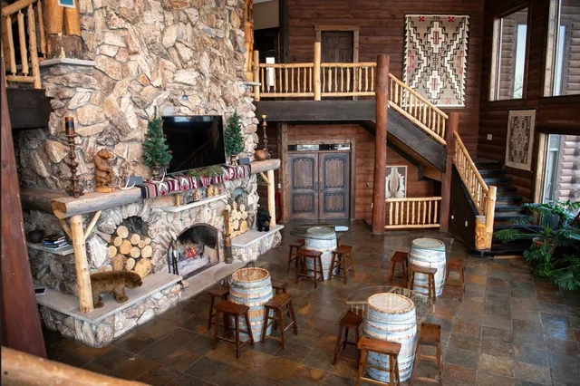 a view of living room that has a fireplace and a flat screen tv