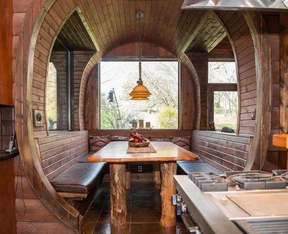 a dining room with glass table and chairs