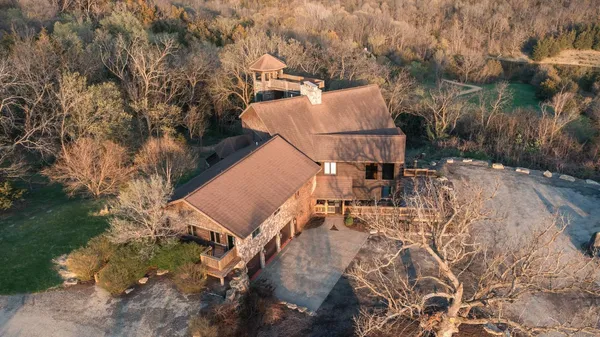 a green field with some trees in the background