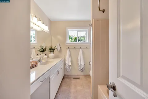a spacious bathroom with a double vanity sink and a mirror