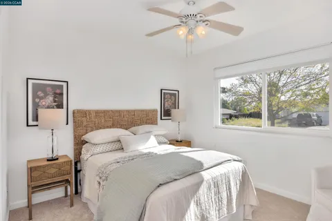 a bedroom with a large bed and a window