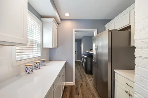 a kitchen with a refrigerator and a sink