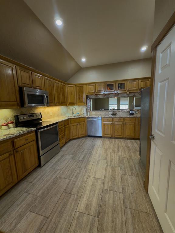 2931 Wall Street Road Howe, TX 75459 - Photo 23 of 38 a large kitchen with wooden floors and stainless steel appliances