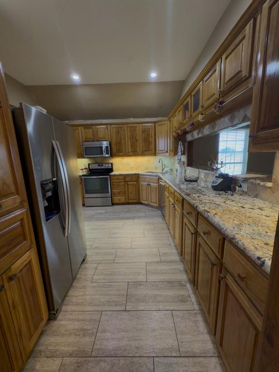 2931 Wall Street Road Howe, TX 75459 - Photo 25 of 38 a kitchen with stainless steel appliances a sink and a refrigerator