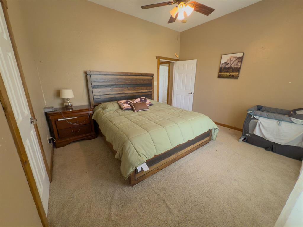 2931 Wall Street Road Howe, TX 75459 - Photo 31 of 38 a bedroom with a bed and a chandelier