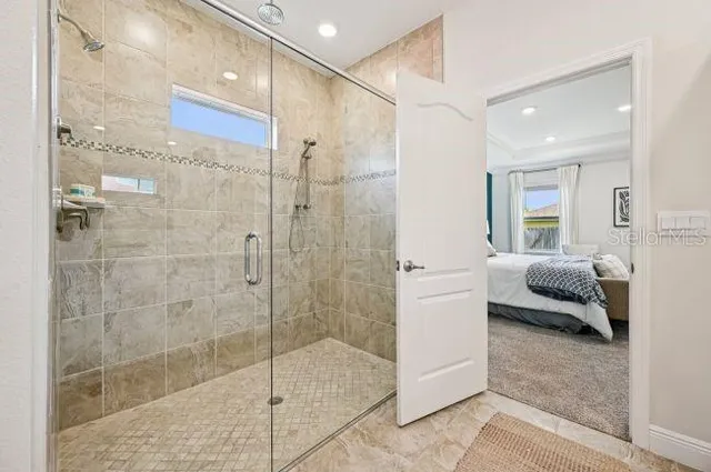 a bathroom with a glass shower door