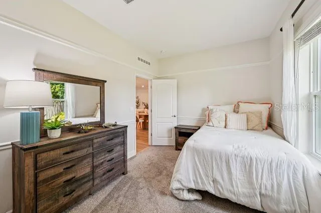 a bedroom with a bed and a dresser