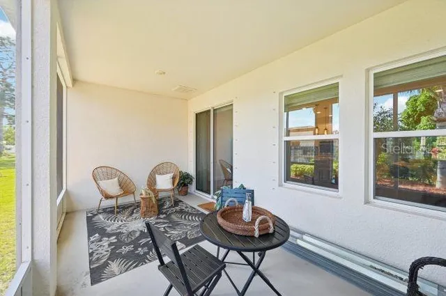 a view of a room that has a table and chairs in it
