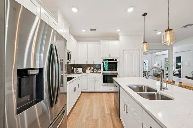 a kitchen with stainless steel appliances sink refrigerator microwave and stove