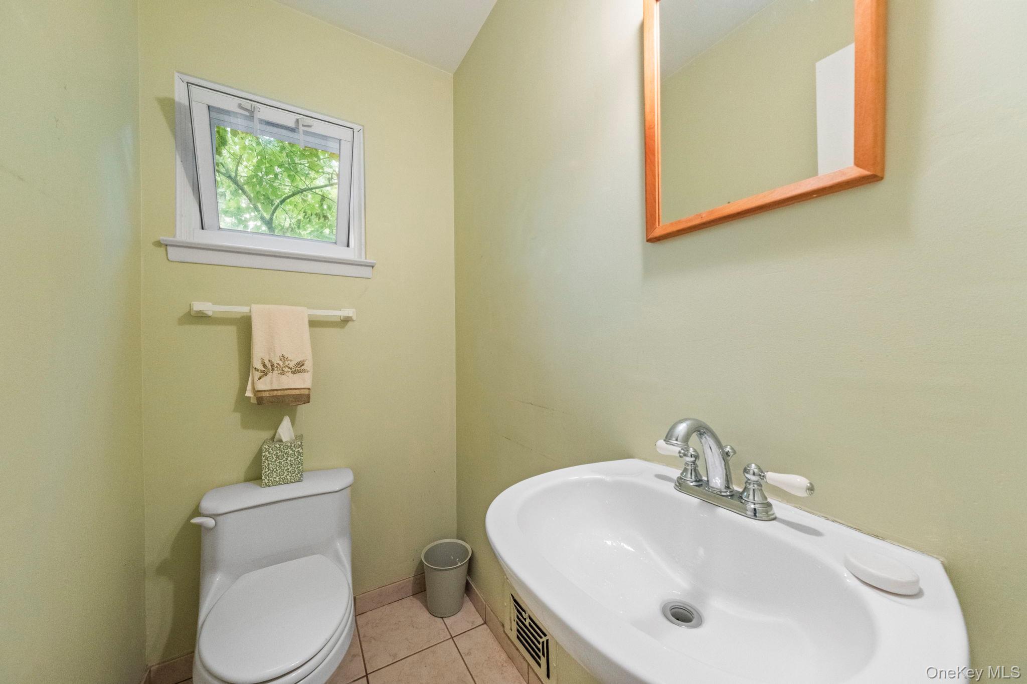 73 Bramblebrook Road Ardsley, NY 10502 - Photo 14 of 35 Half bathroom featuring a corner sink with chrome faucet, light-toned wall paint, and tile flooring