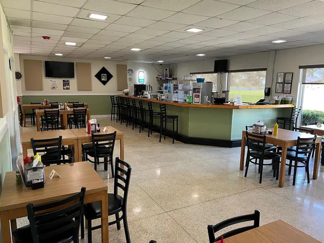 swimming pool view with a seating space