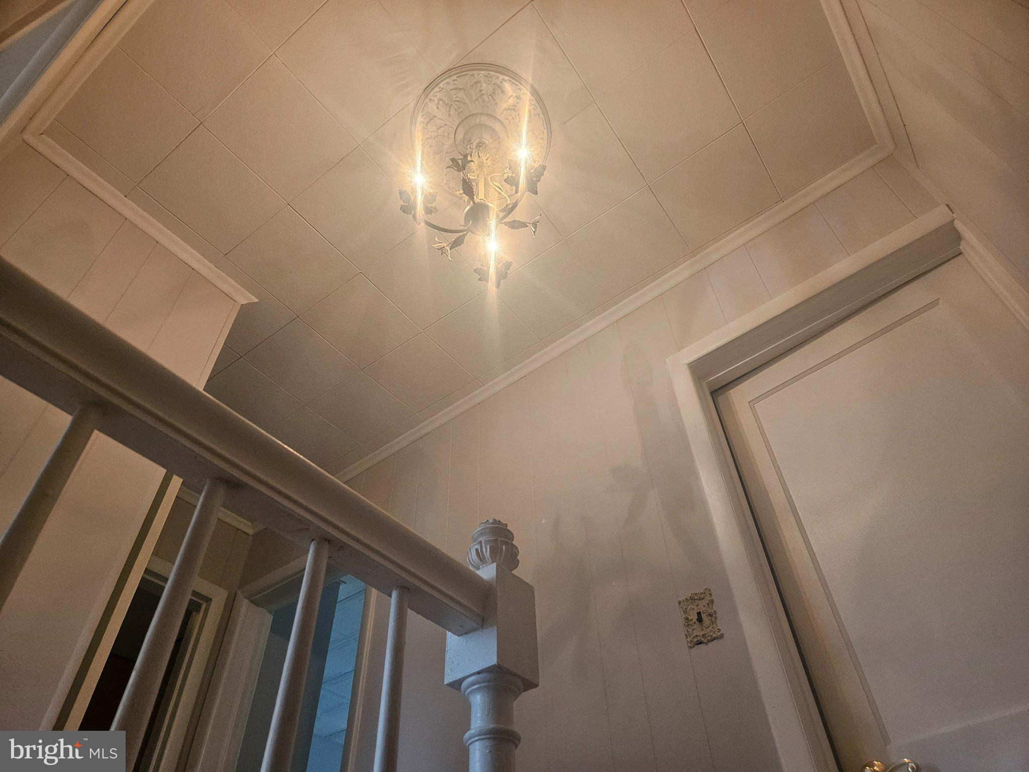 635 48th Street Baltimore, MD 21224 - Photo 7 of 14 Elegant staircase under soft lighting.