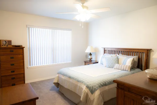 a bedroom with a bed and a dresser