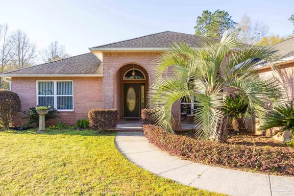 a front view of a house with garden