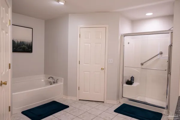 a bathroom with a bathtub and shower