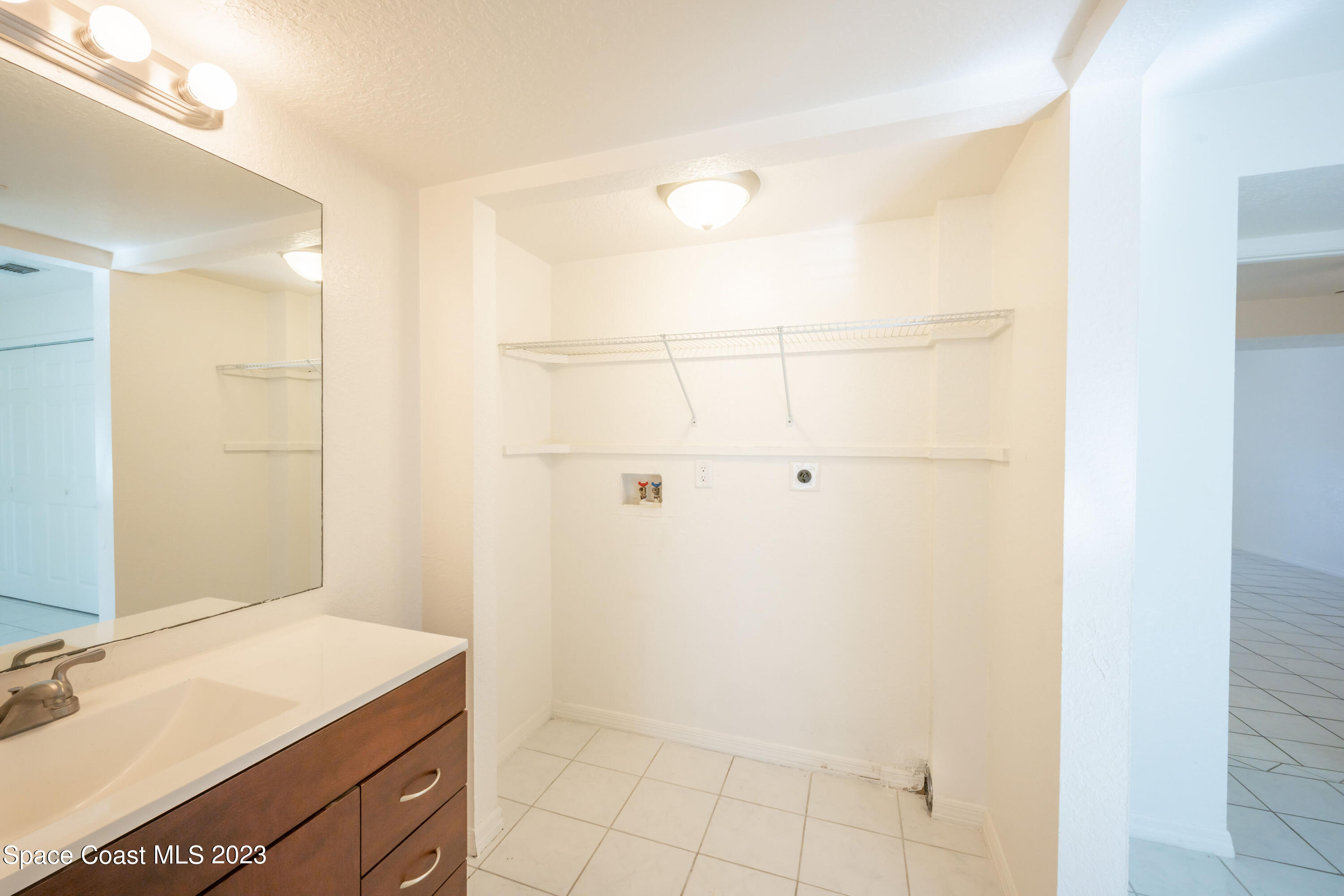 1130 Gary Hunt Road, Unit B Cocoa, FL 32926 - Photo 15 of 33 a bathroom with a sink vanity and a mirror