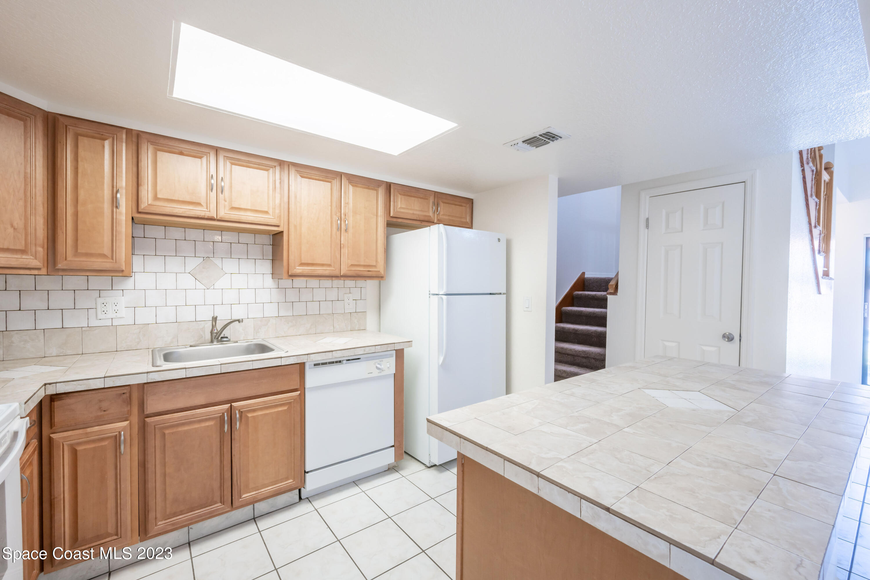 1130 Gary Hunt Road, Unit B Cocoa, FL 32926 - Photo 6 of 33 a kitchen with a sink a stove a refrigerator and cabinets