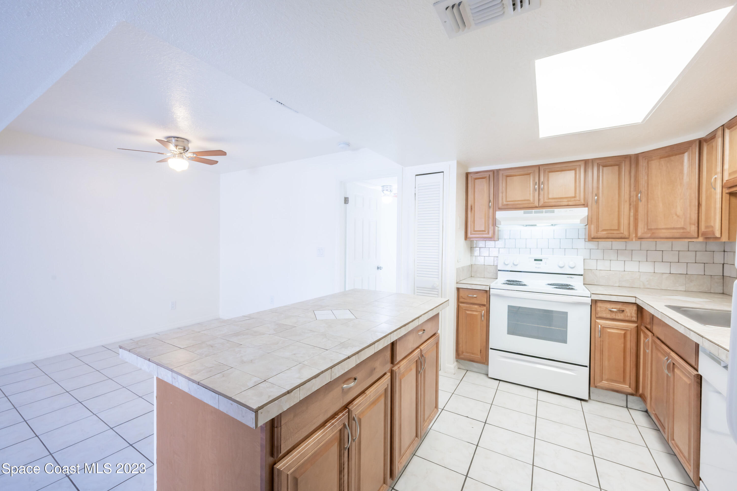 1130 Gary Hunt Road, Unit B Cocoa, FL 32926 - Photo 8 of 33 a kitchen with a stove a sink and a refrigerator