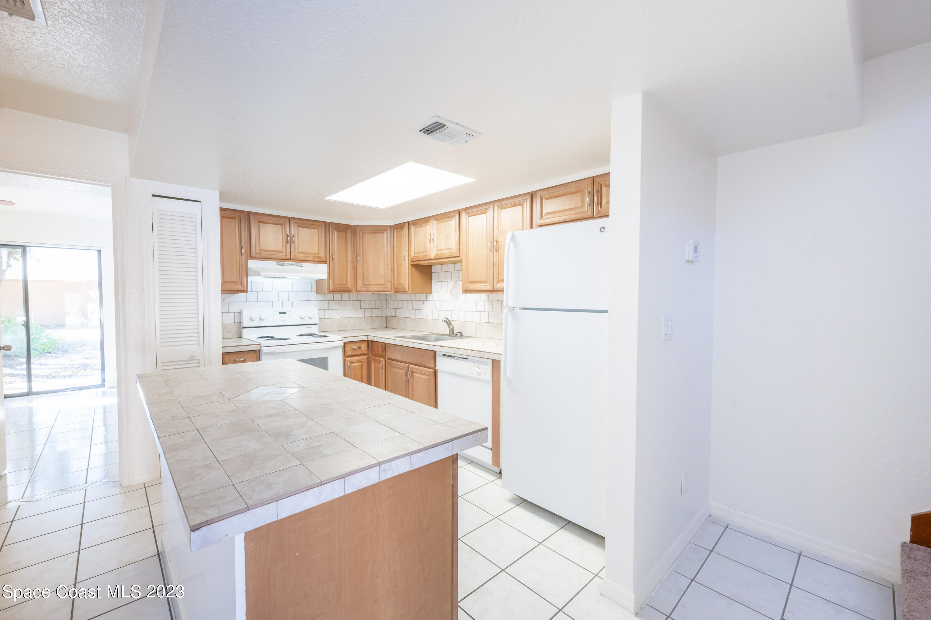 1130 Gary Hunt Road, Unit B Cocoa, FL 32926 - Photo 9 of 33 a kitchen with a refrigerator a stove top oven and a refrigerator