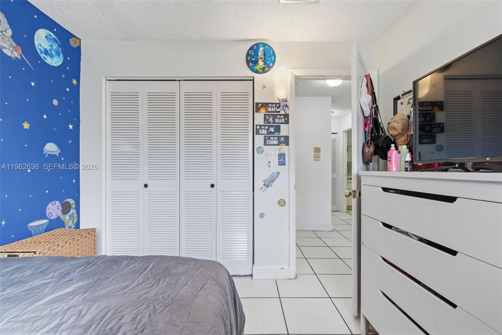4726 Southwest 67th Avenue, Unit F6 Miami, FL 33155 - Photo 26 of 37 a bedroom with a bed and a flat screen tv