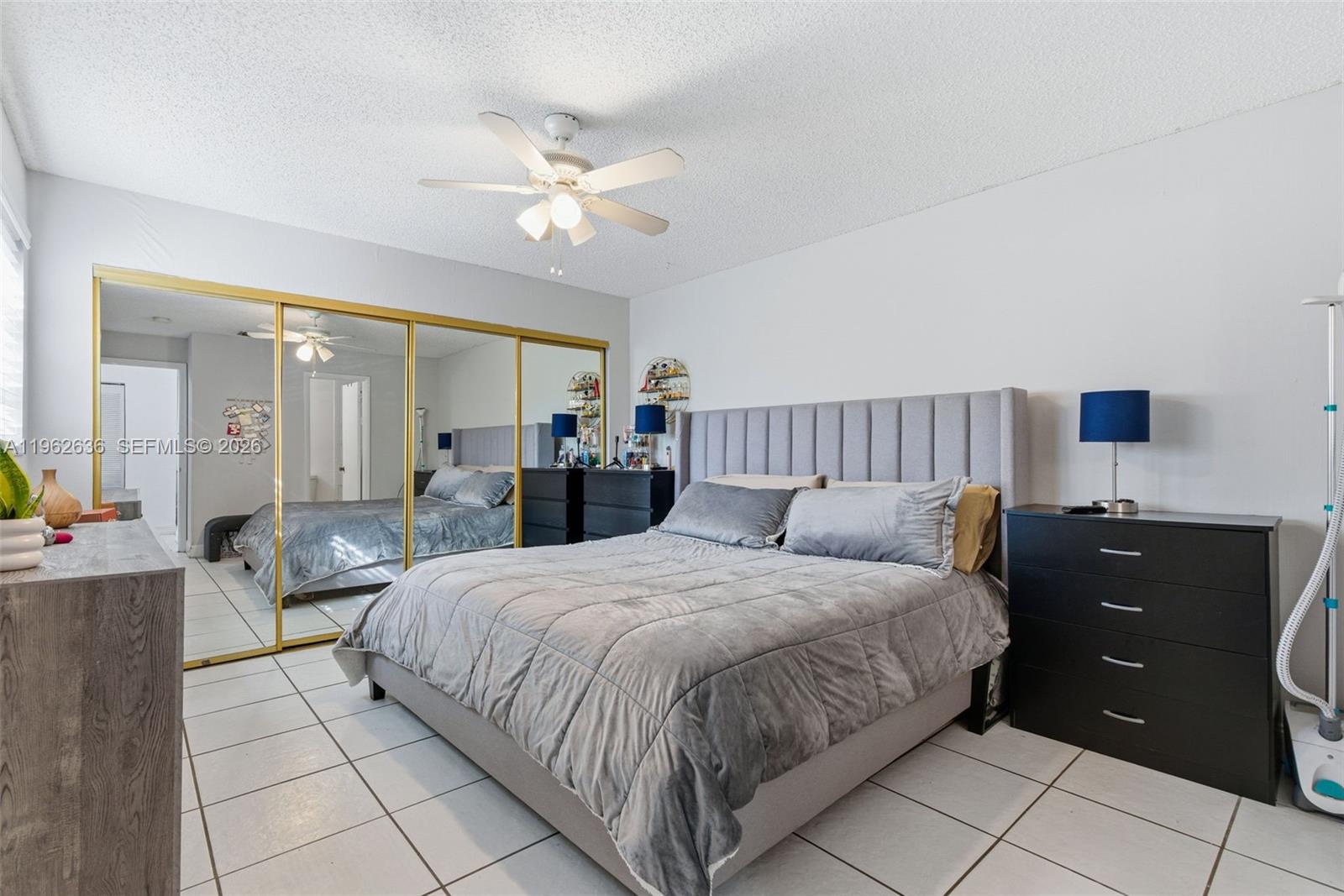 4726 Southwest 67th Avenue, Unit F6 Miami, FL 33155 - Photo 27 of 37 a bedroom with a bed and a chandelier