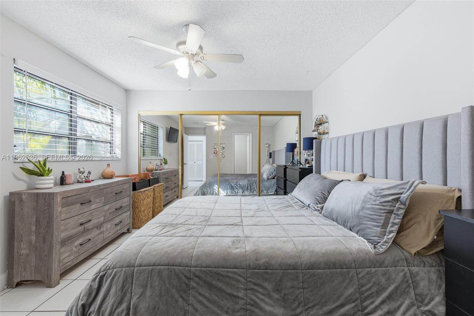 4726 Southwest 67th Avenue, Unit F6 Miami, FL 33155 - Photo 29 of 37 a bedroom with bed and window