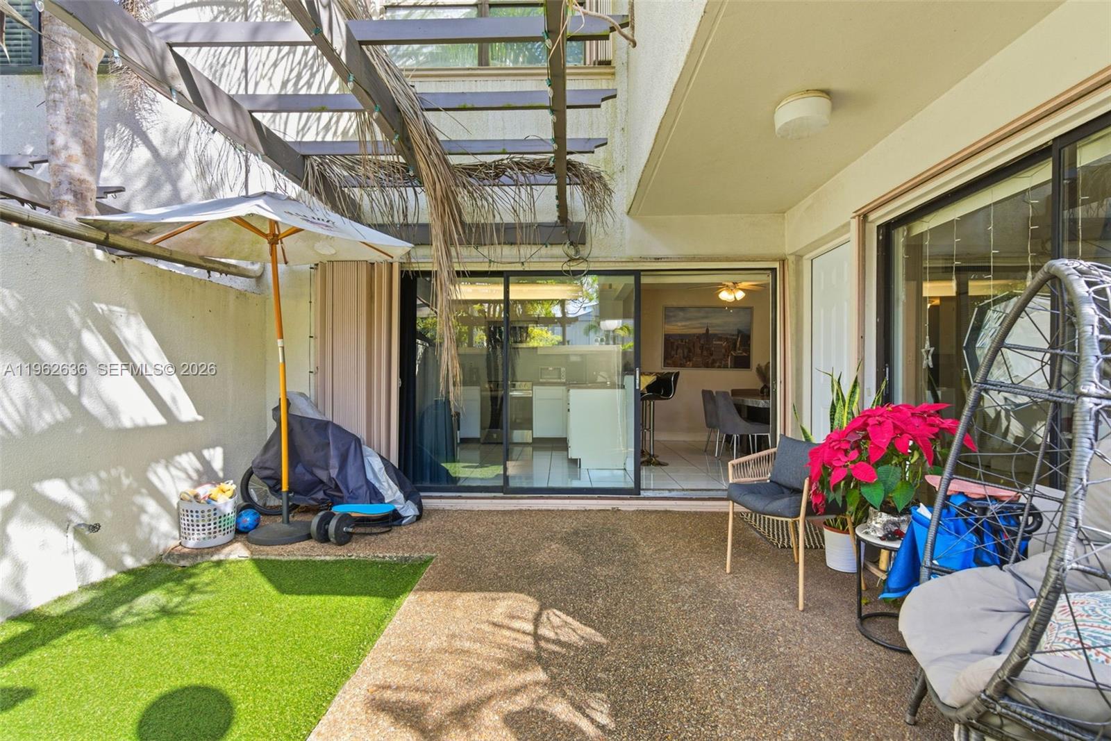 4726 Southwest 67th Avenue, Unit F6 Miami, FL 33155 - Photo 4 of 37 a view of a chairs and table in patio with a backyard
