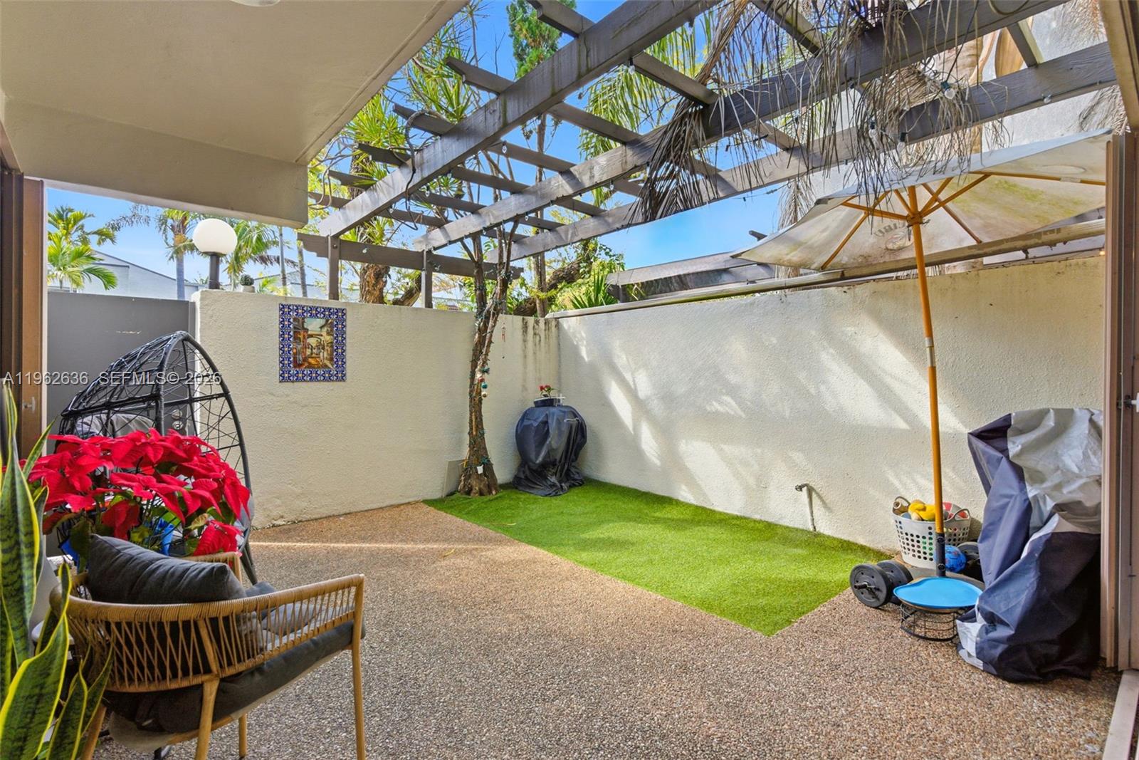 4726 Southwest 67th Avenue, Unit F6 Miami, FL 33155 - Photo 6 of 37 a backyard with furniture and a potted plant