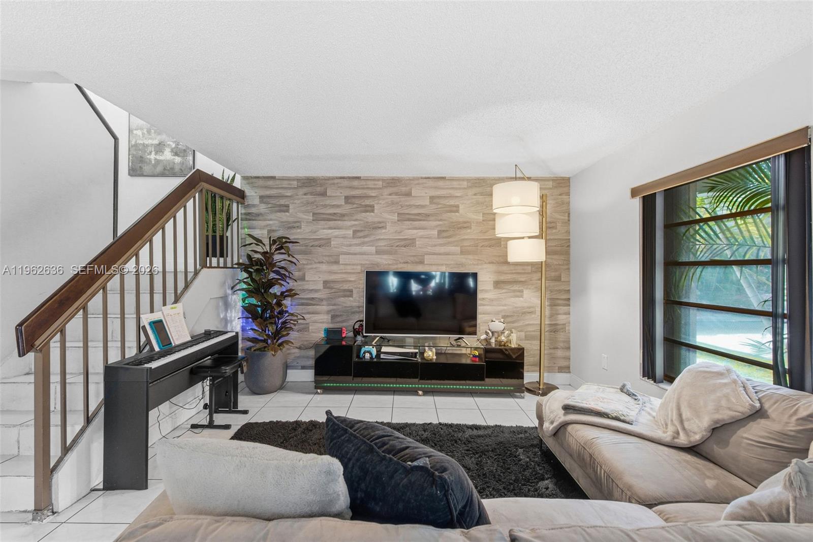 4726 Southwest 67th Avenue, Unit F6 Miami, FL 33155 - Photo 8 of 37 a living room with furniture flat screen tv and a fireplace