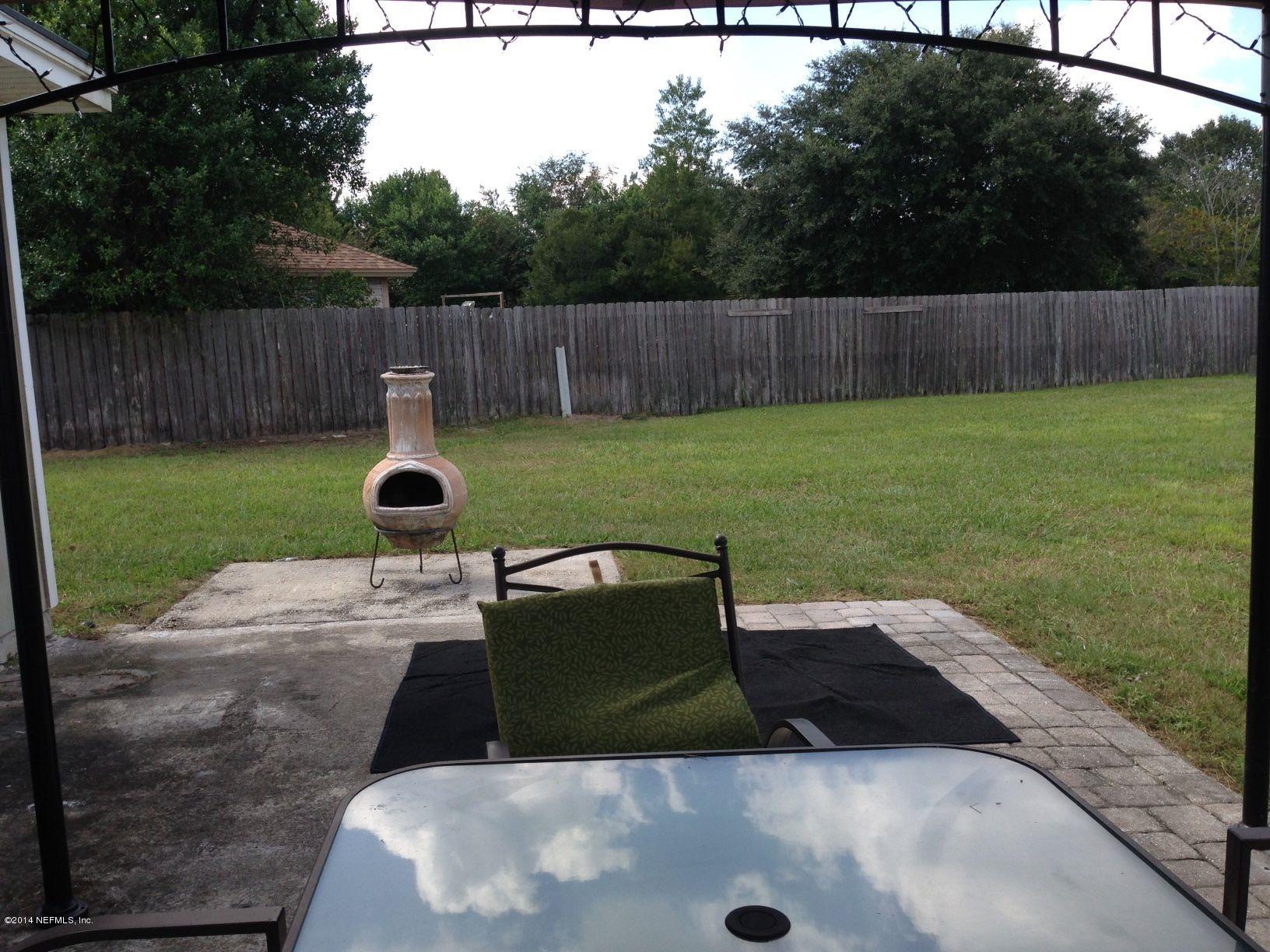 438 Federal Hill Road Orange Park, FL 32073 - Photo 14 of 14 a view of a backyard with wooden fence