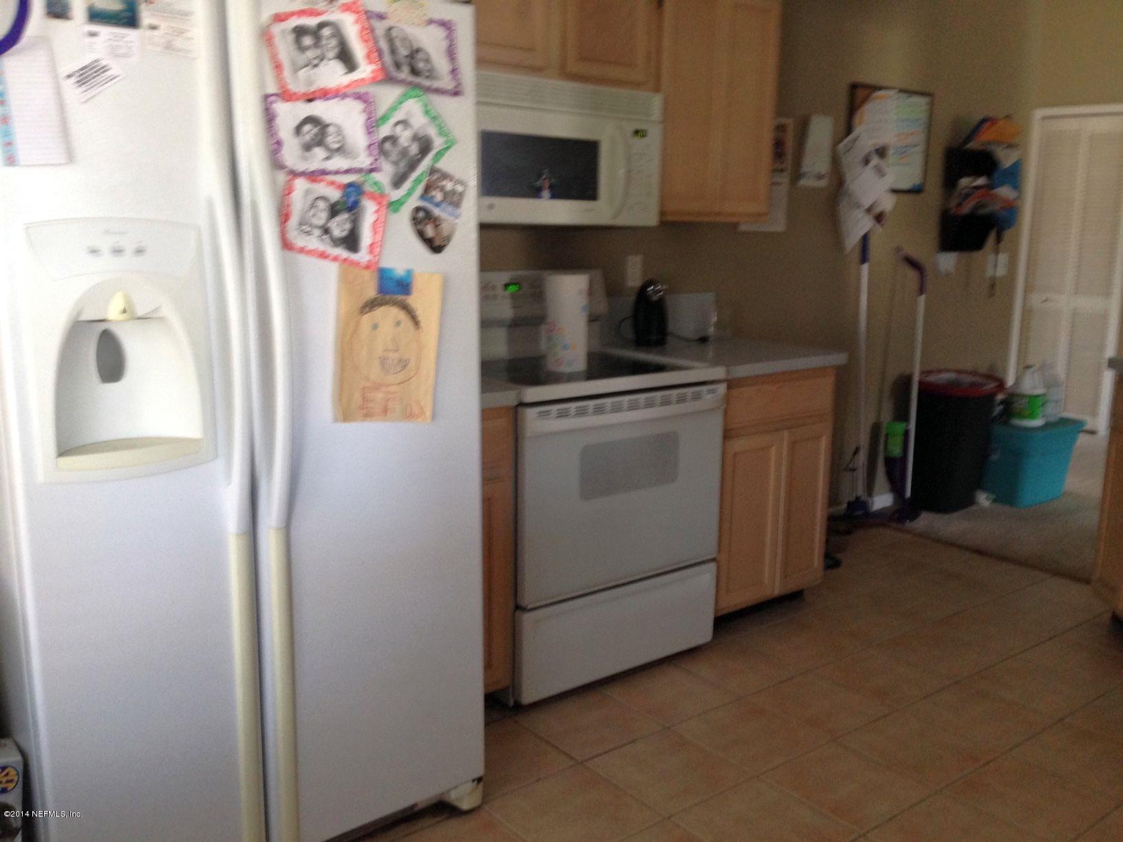 438 Federal Hill Road Orange Park, FL 32073 - Photo 3 of 14 a kitchen with a refrigerator and a stove