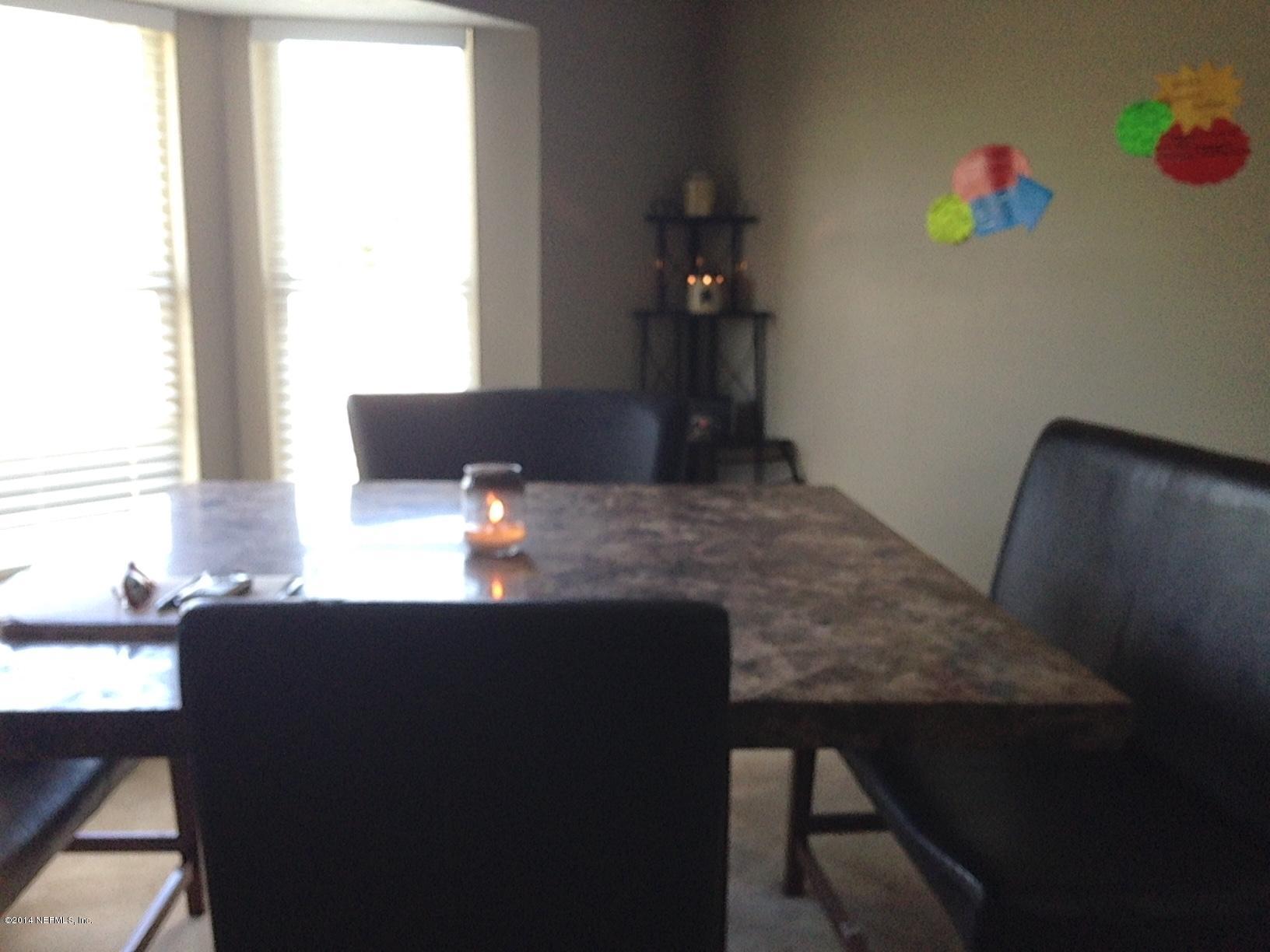 438 Federal Hill Road Orange Park, FL 32073 - Photo 5 of 14 a room with a table chairs and a refrigerator