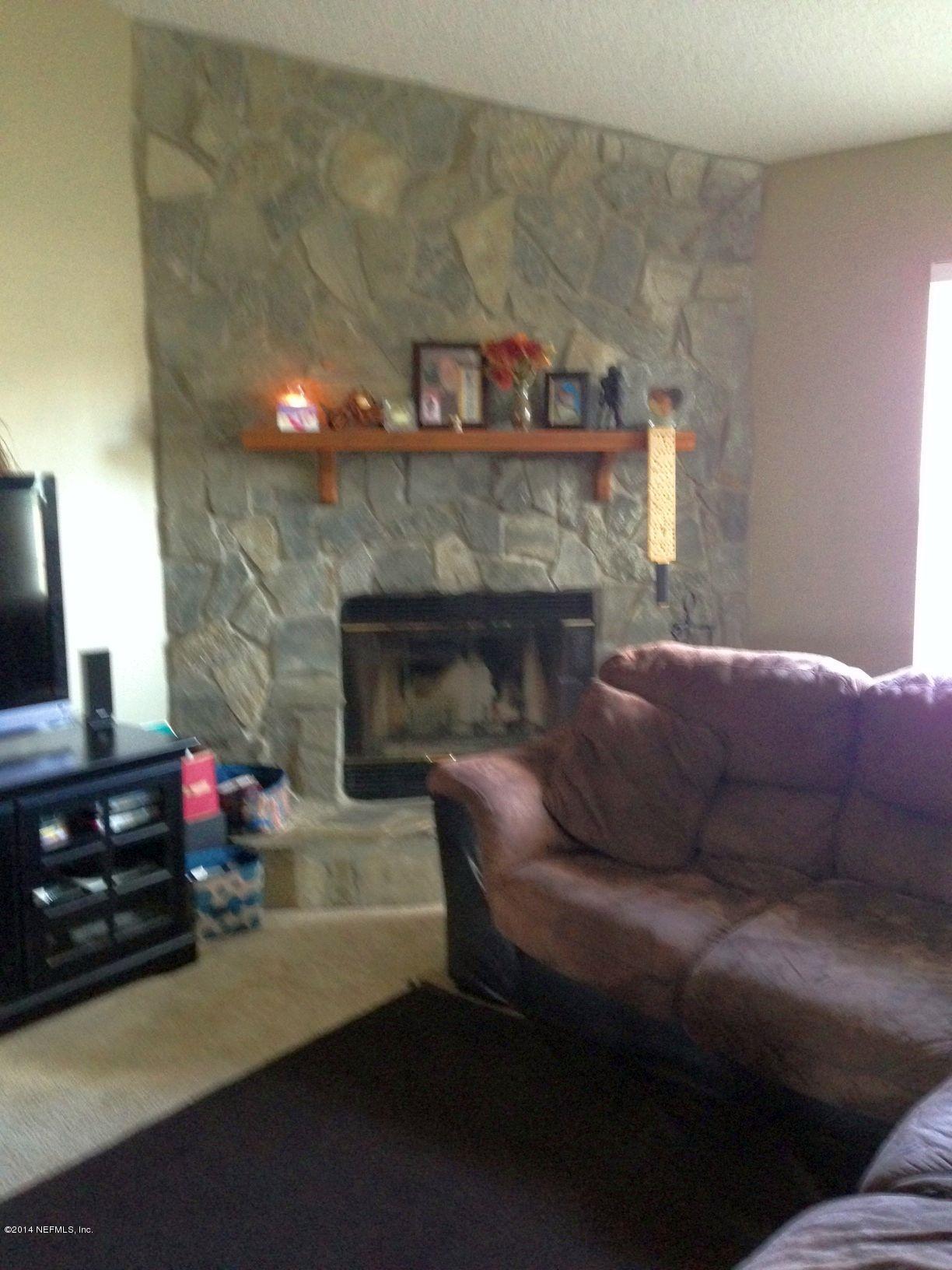 438 Federal Hill Road Orange Park, FL 32073 - Photo 6 of 14 a living room with furniture and a fireplace