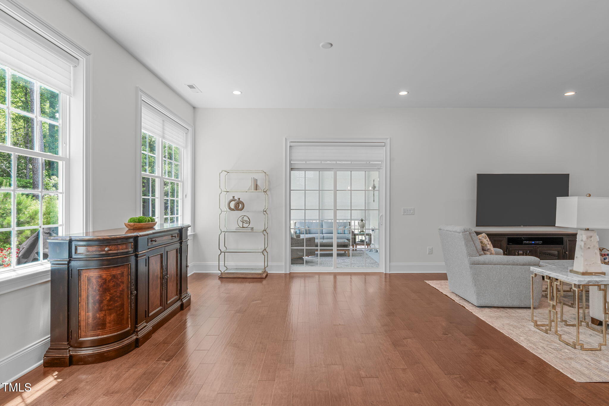 2511 Range Overlook Crossing Apex, NC 27523 - Photo 20 of 50 a living room with furniture a flat screen tv and large windows