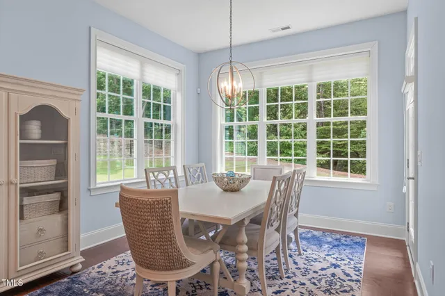 a dining room with furniture window and outside view