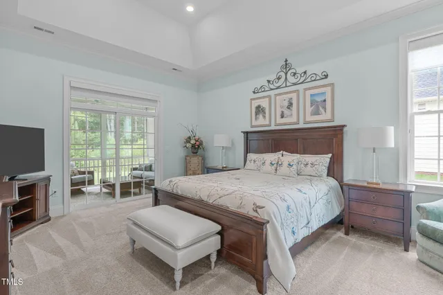 a bedroom with furniture and a flat screen tv