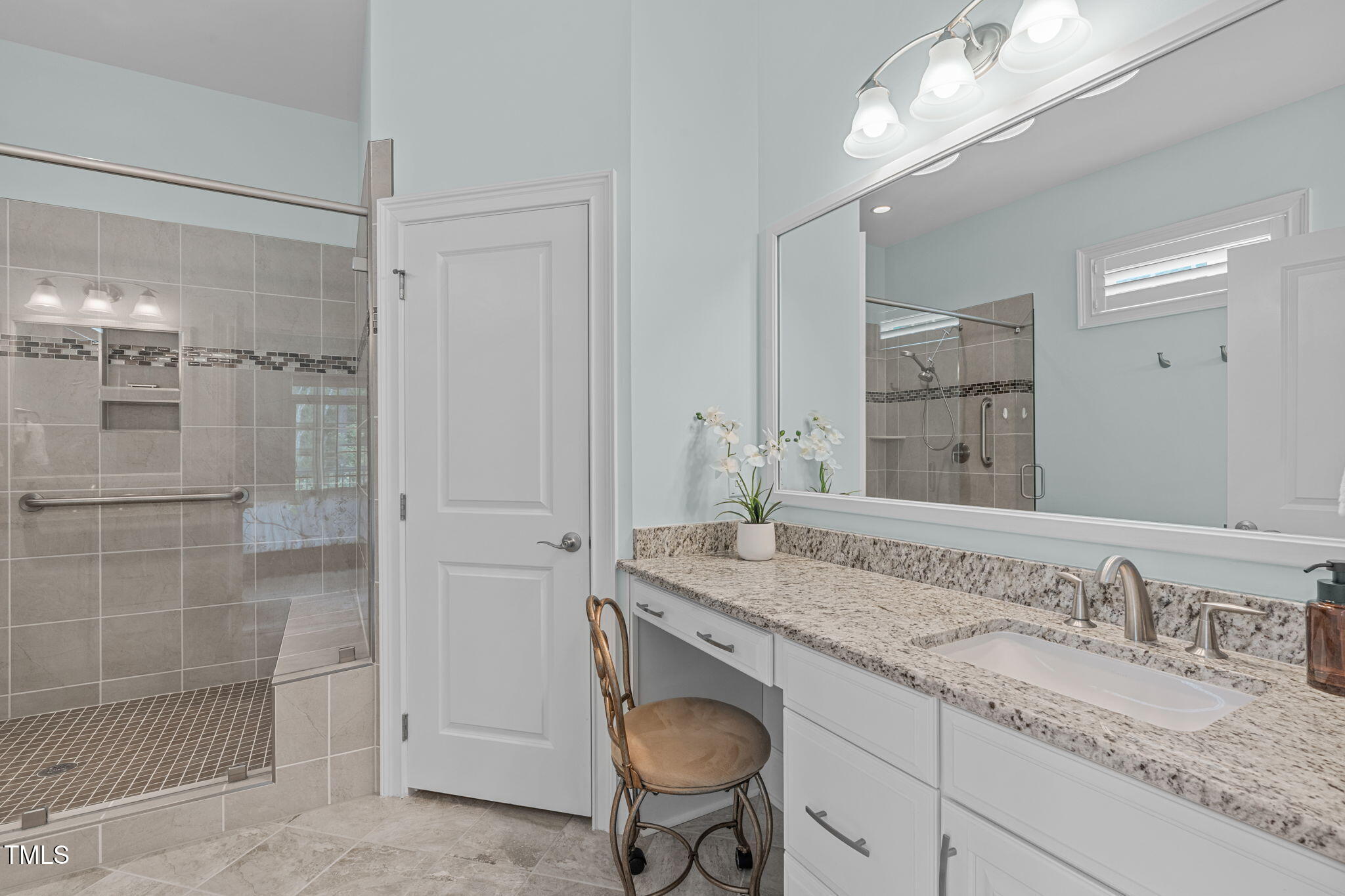 2511 Range Overlook Crossing Apex, NC 27523 - Photo 27 of 50 a bathroom with a granite countertop sink a mirror and shower