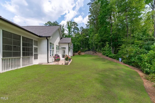 a view of a backyard with a garden and seating area